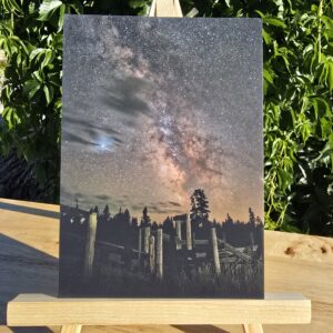 Postcard featuring Milky Way Over Corral displayed on a small wooden easel